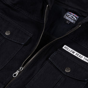 Close-up of a black jacket with visible branding on a dark background